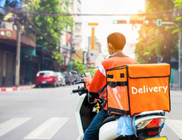 A delivery rider carrying a food order