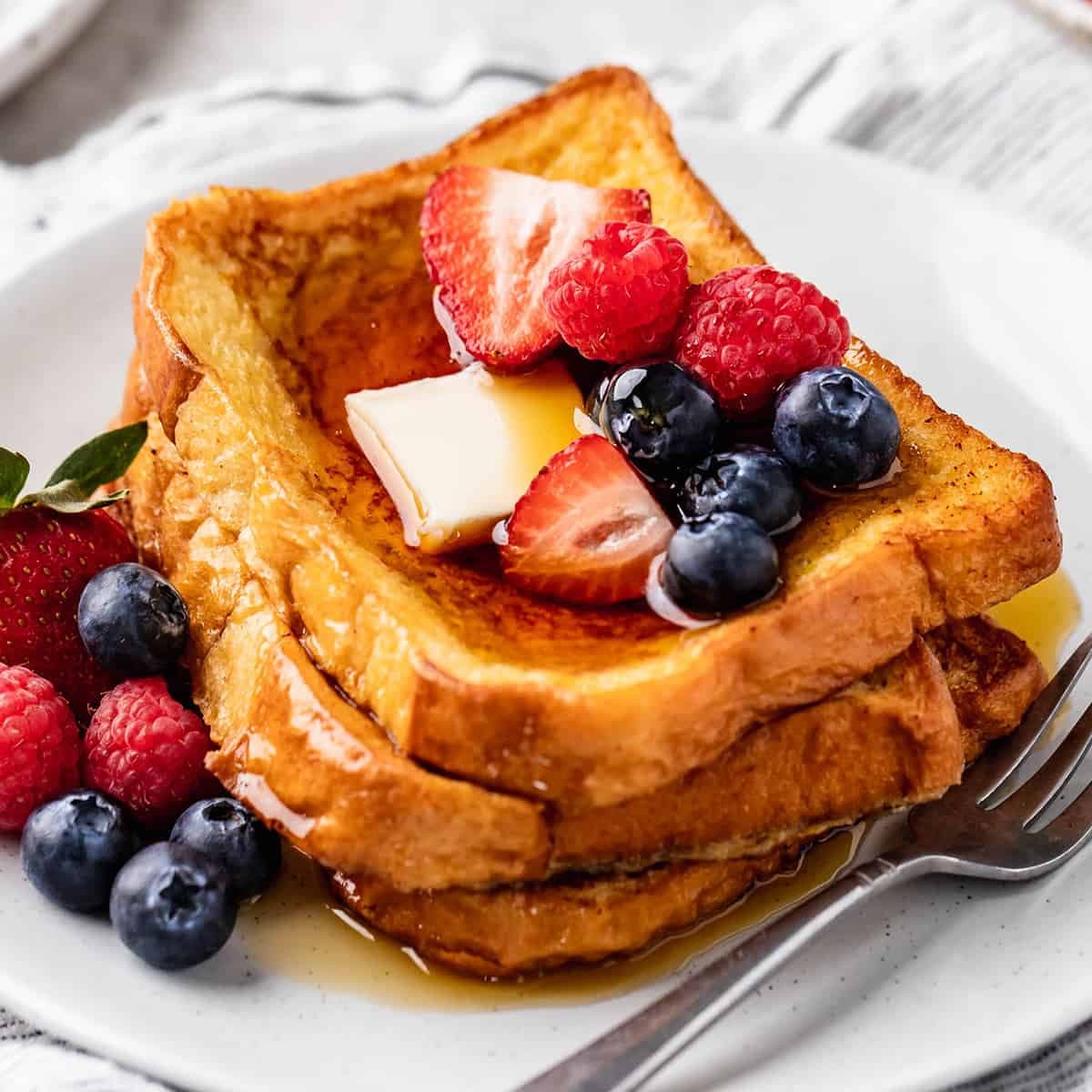 Golden French toast topped with fresh berries